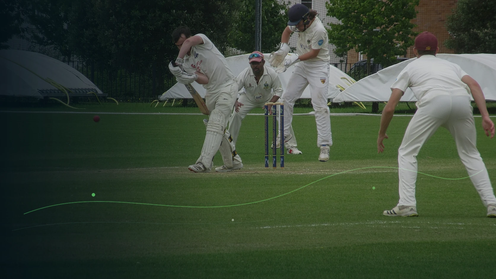 A batter playing a forceful shot during an adult club cricket match