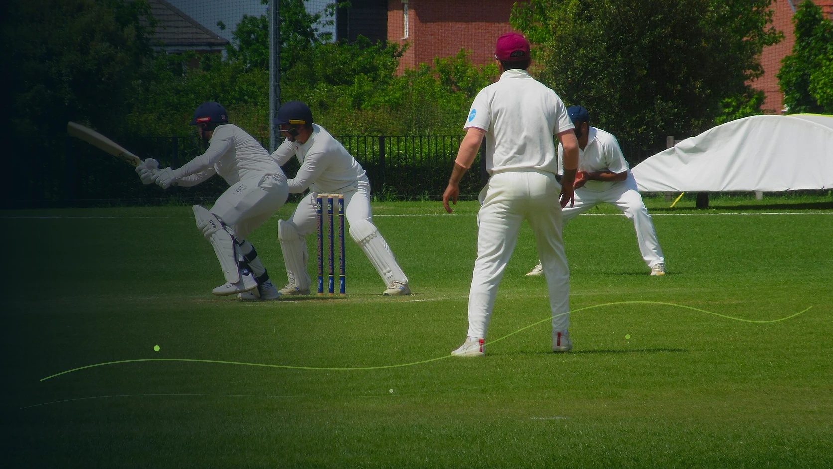 A batter meeting the ball as wicketkeeper and close fielders react