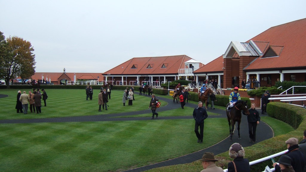 Jockeys and horses in Newmarket's parade ring in October 2010