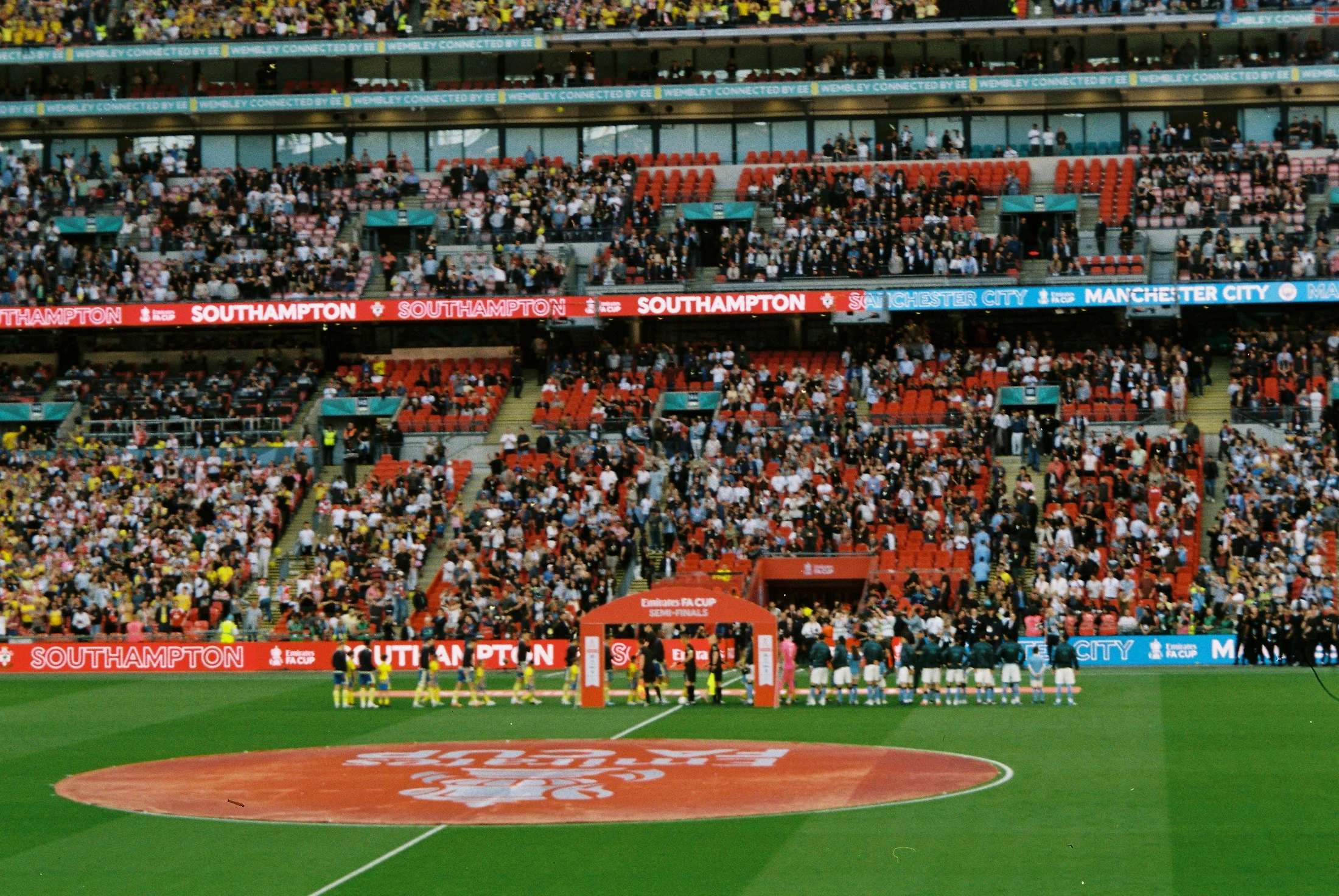 Teams lining up on the pitch at Wembley before a football match